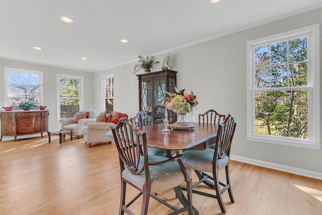 dining area with crown molding, light wood finished floors, recessed lighting, and baseboards