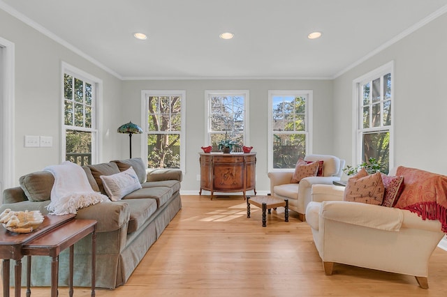 living area featuring ornamental molding, recessed lighting, light wood-style flooring, and baseboards