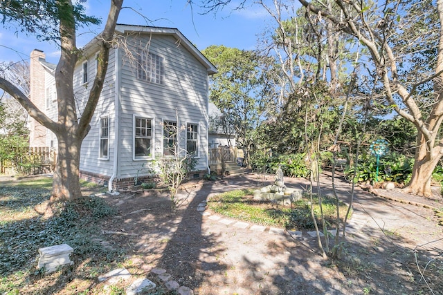 view of property exterior featuring crawl space and fence