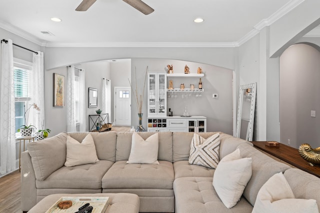 2802 Cavalcade Cir, Johns Island, SC 29455 - living area with arched walkways, bar area, crown molding, wood finished floors, and recessed lighting
