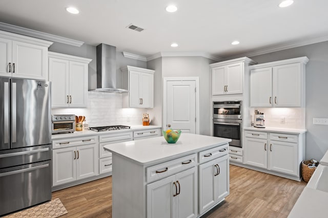 2802 Cavalcade Cir, Johns Island, SC 29455 - kitchen with stainless steel appliances, wall chimney exhaust hood, crown molding, light countertops, and white cabinetry