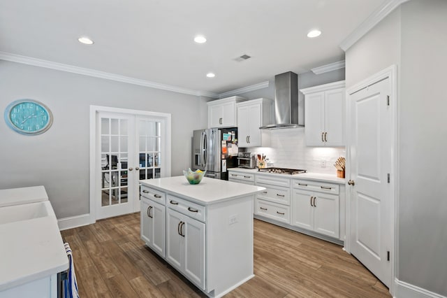 2802 Cavalcade Cir, Johns Island, SC 29455 - kitchen with appliances with stainless steel finishes, french doors, wall chimney range hood, ornamental molding, and tasteful backsplash