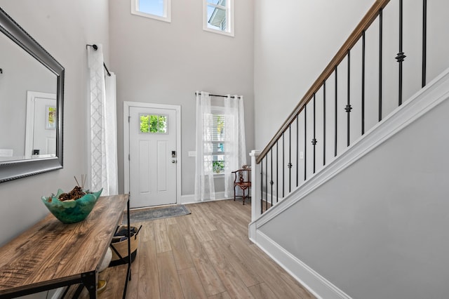 2802 Cavalcade Cir, Johns Island, SC 29455 - foyer with a towering ceiling, light wood-style flooring, healthy amount of natural light, stairway, and baseboards