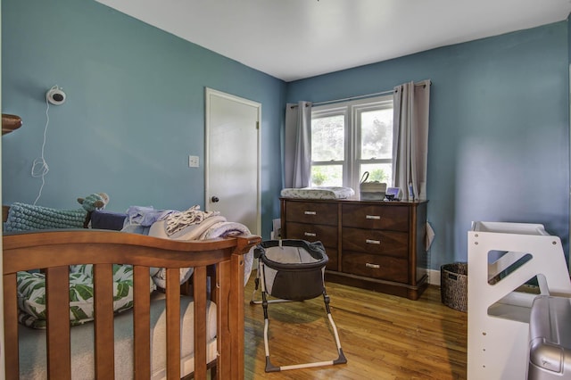 bedroom with baseboards and light wood finished floors