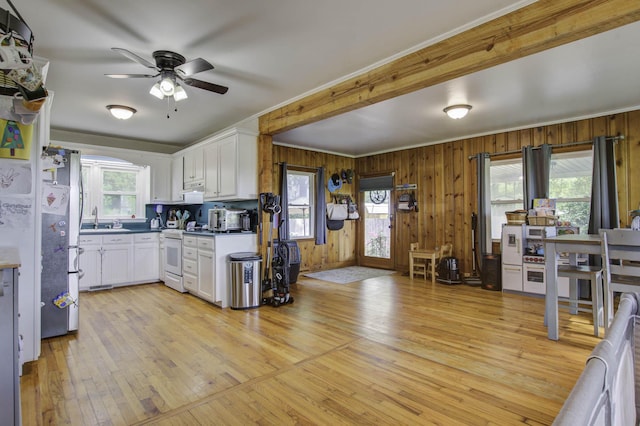 kitchen with freestanding refrigerator, light wood finished floors, white electric range oven, and white cabinetry