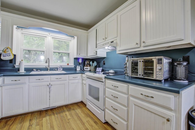 kitchen with under cabinet range hood, white electric range, a sink, white cabinets, and dark countertops