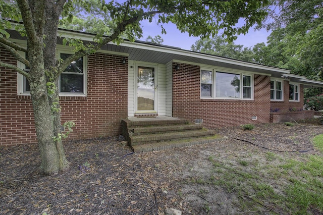 ranch-style home featuring crawl space and brick siding