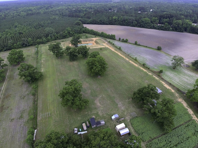 birds eye view of property featuring a wooded view and a rural view