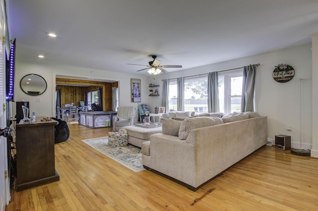 living room with light wood finished floors, baseboards, a ceiling fan, and recessed lighting