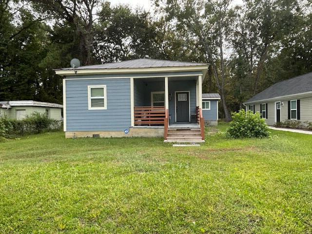 5309 Good St, North Charleston, SC 29406 - view of front facade featuring covered porch and a front lawn