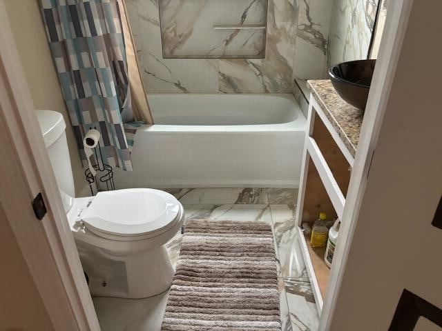 full bathroom with vanity, toilet, and shower / bathtub combination with curtain