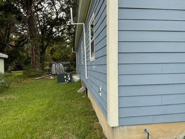 view of property exterior with a yard