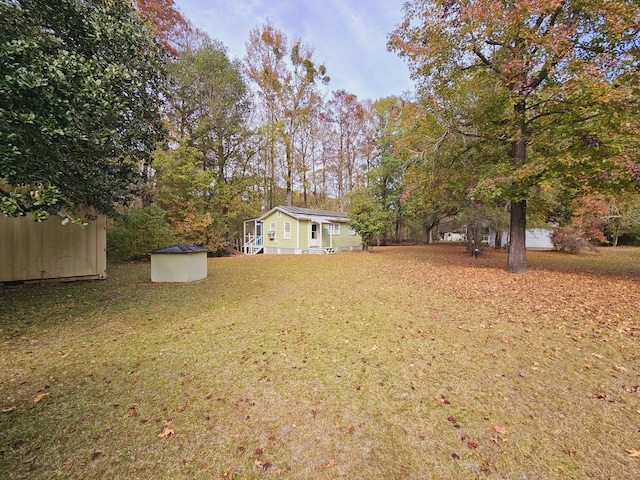 view of yard with an outbuilding and a storage shed