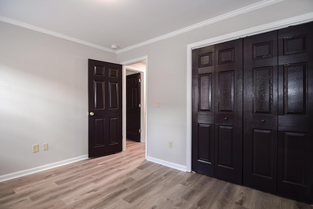 bedroom with a closet, light hardwood / wood-style flooring, and ornamental molding