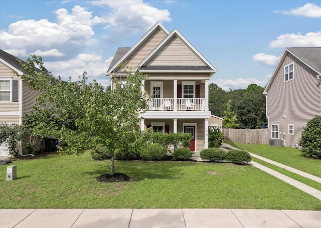 view of front facade featuring central AC unit, a balcony, a front lawn, and covered porch