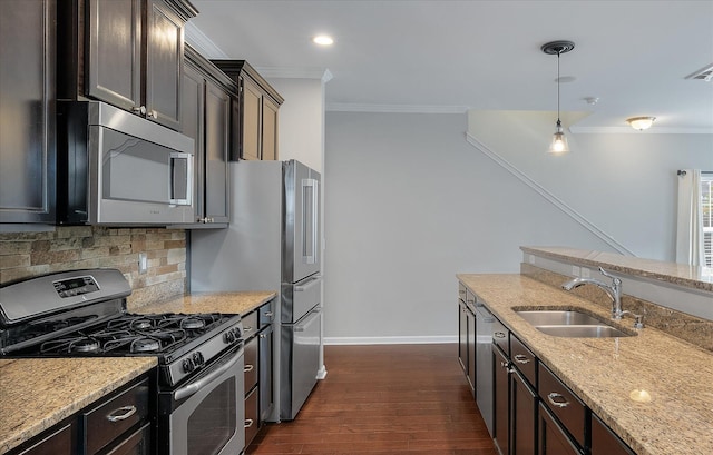 kitchen with sink, decorative light fixtures, stainless steel appliances, dark hardwood / wood-style floors, and light stone countertops