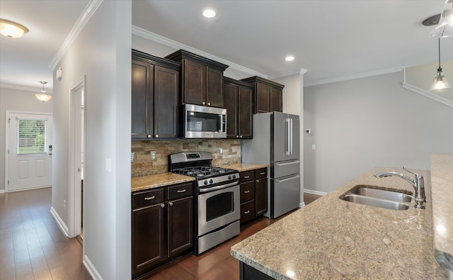 kitchen with light stone counters, dark hardwood / wood-style flooring, stainless steel appliances, crown molding, and sink