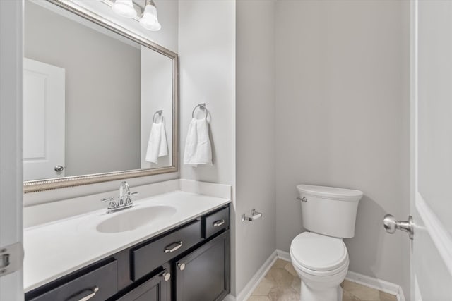 bathroom featuring vanity, toilet, and tile patterned floors