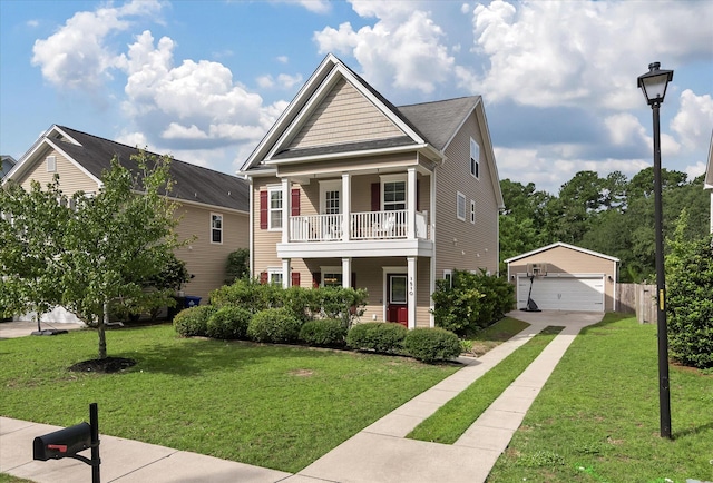 view of front facade with an outbuilding, a balcony, a garage, and a front lawn