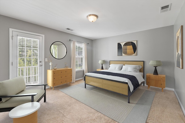 carpeted bedroom featuring multiple windows