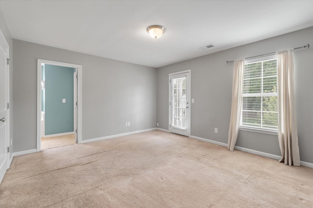 carpeted empty room featuring a healthy amount of sunlight