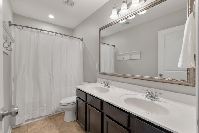 bathroom with tile patterned flooring, walk in shower, vanity, and toilet