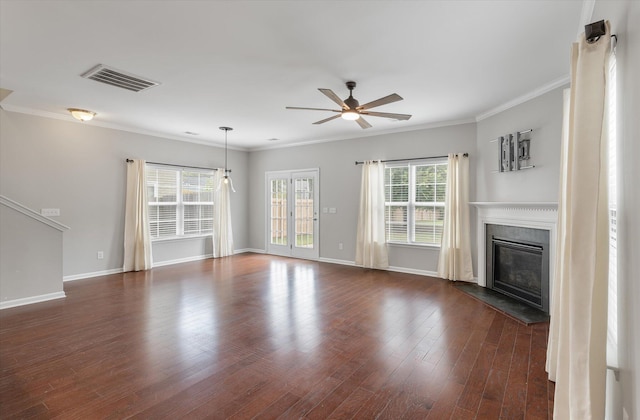 unfurnished living room with ceiling fan, plenty of natural light, dark wood-type flooring, and crown molding