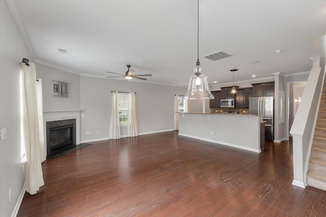 unfurnished living room featuring ceiling fan, crown molding, and dark hardwood / wood-style flooring