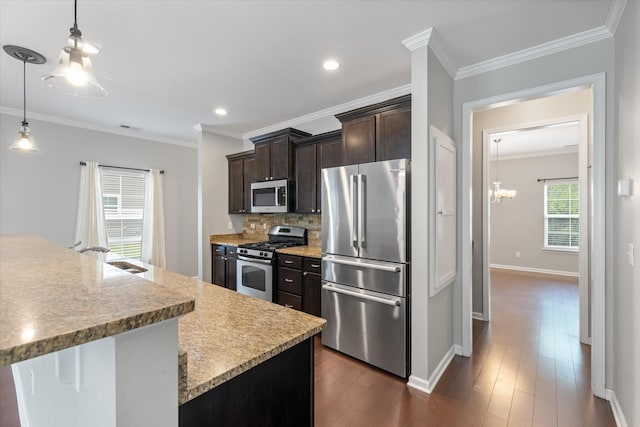 kitchen with pendant lighting, sink, dark brown cabinets, dark wood-type flooring, and stainless steel appliances