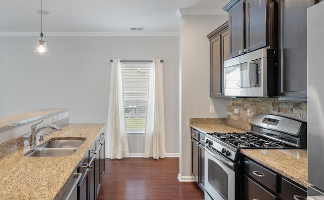 kitchen featuring light stone counters, dark hardwood / wood-style floors, sink, stainless steel appliances, and dark brown cabinetry