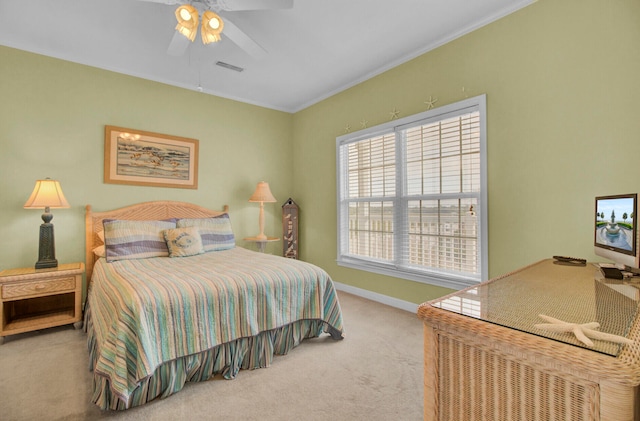 bedroom with carpet, ceiling fan, and crown molding