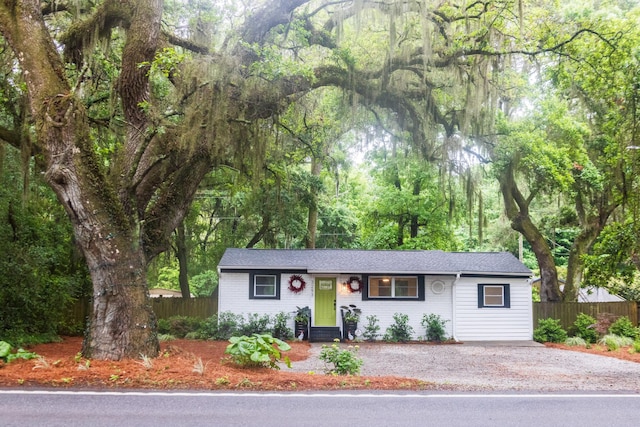 view of front of home featuring fence and driveway