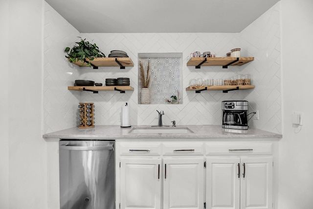 indoor wet bar with stainless steel dishwasher and tasteful backsplash
