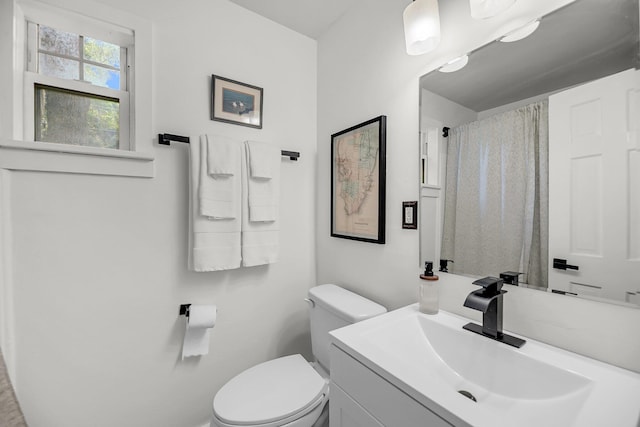 bathroom featuring toilet and vanity