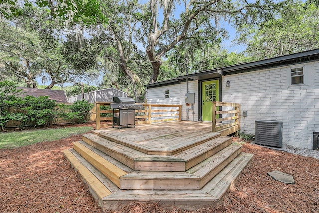 deck with central AC unit, grilling area, and fence