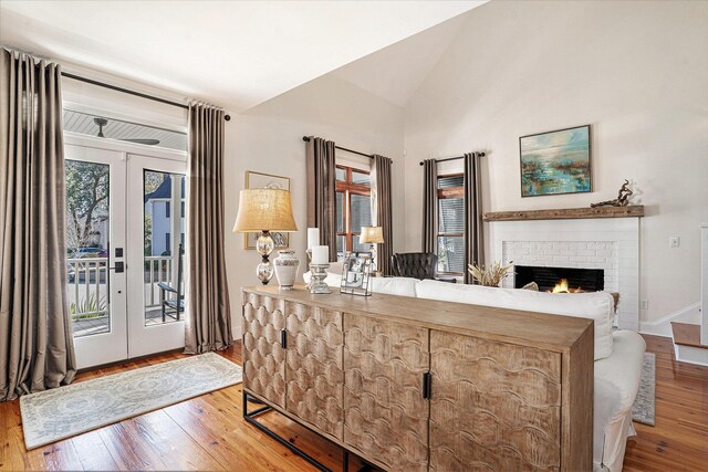 entryway featuring hardwood / wood-style flooring, vaulted ceiling, french doors, and a healthy amount of sunlight