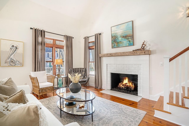 living room featuring wood-type flooring and a fireplace