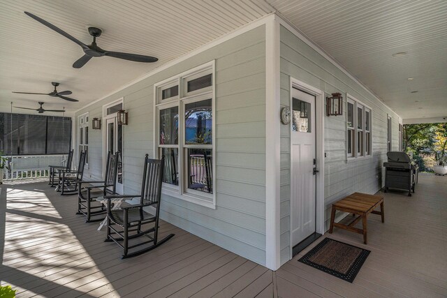 wooden terrace with ceiling fan and a porch