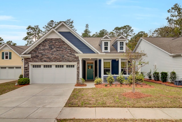 view of front of home with a garage, a porch, and a front lawn