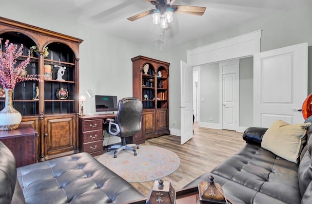 home office featuring light hardwood / wood-style flooring and ceiling fan