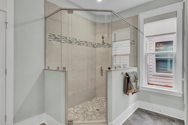 bathroom with walk in shower and tile patterned floors