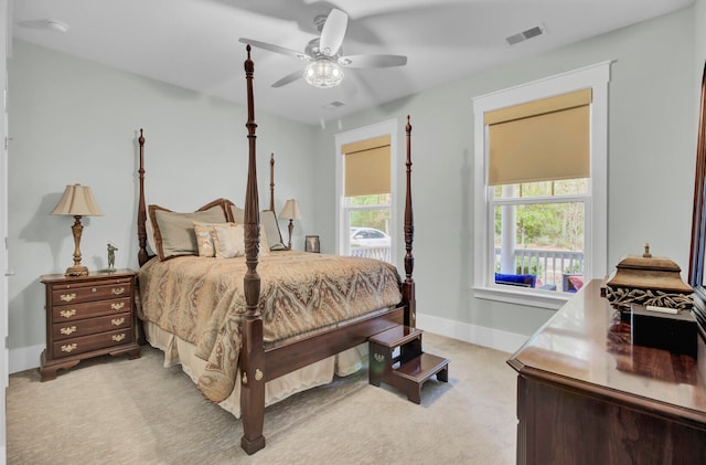 bedroom featuring ceiling fan and light carpet