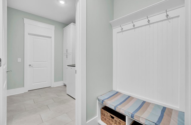 mudroom featuring light tile patterned floors and washer / dryer