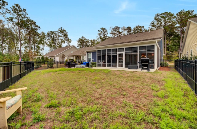 back of property with a sunroom and a yard