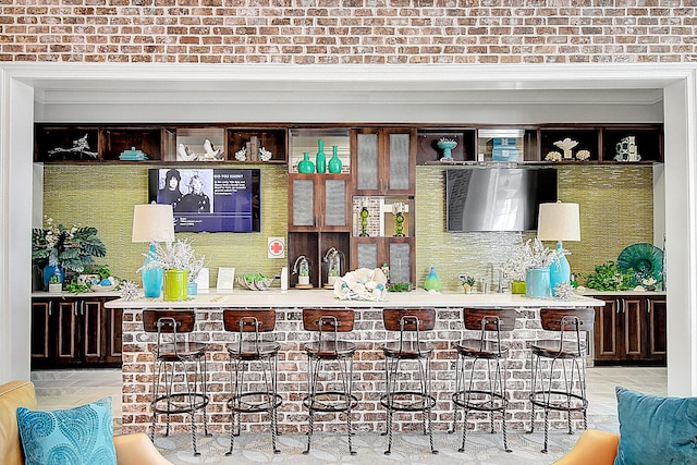 bar with dark brown cabinetry