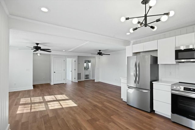 kitchen featuring ceiling fan with notable chandelier, appliances with stainless steel finishes, white cabinets, and dark wood-type flooring