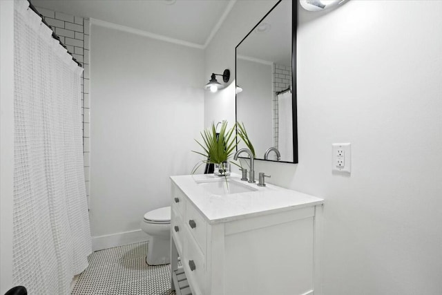 bathroom with tile patterned flooring, baseboards, toilet, ornamental molding, and vanity