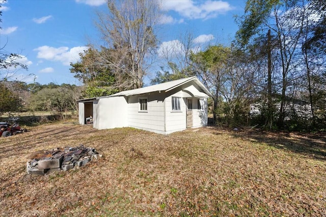 view of side of property with a lawn