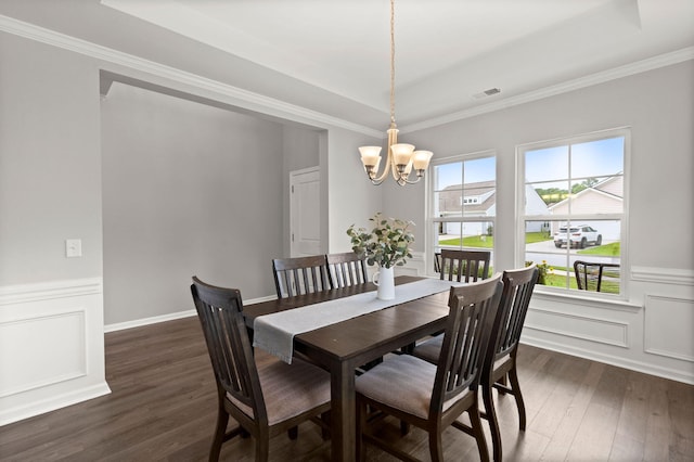 dining area featuring a chandelier, dark hardwood / wood-style flooring, and a tray ceiling