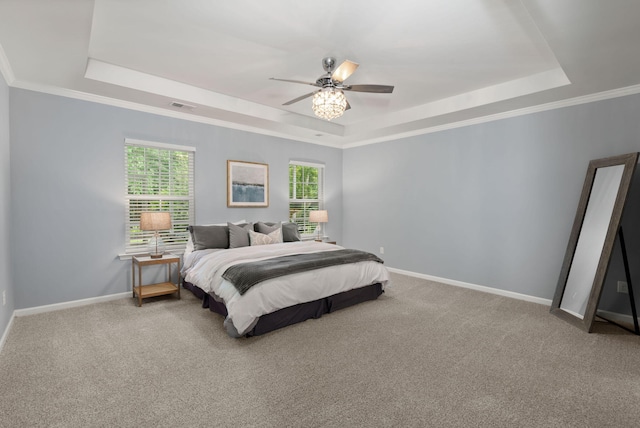 bedroom featuring ceiling fan, a raised ceiling, carpet floors, and crown molding